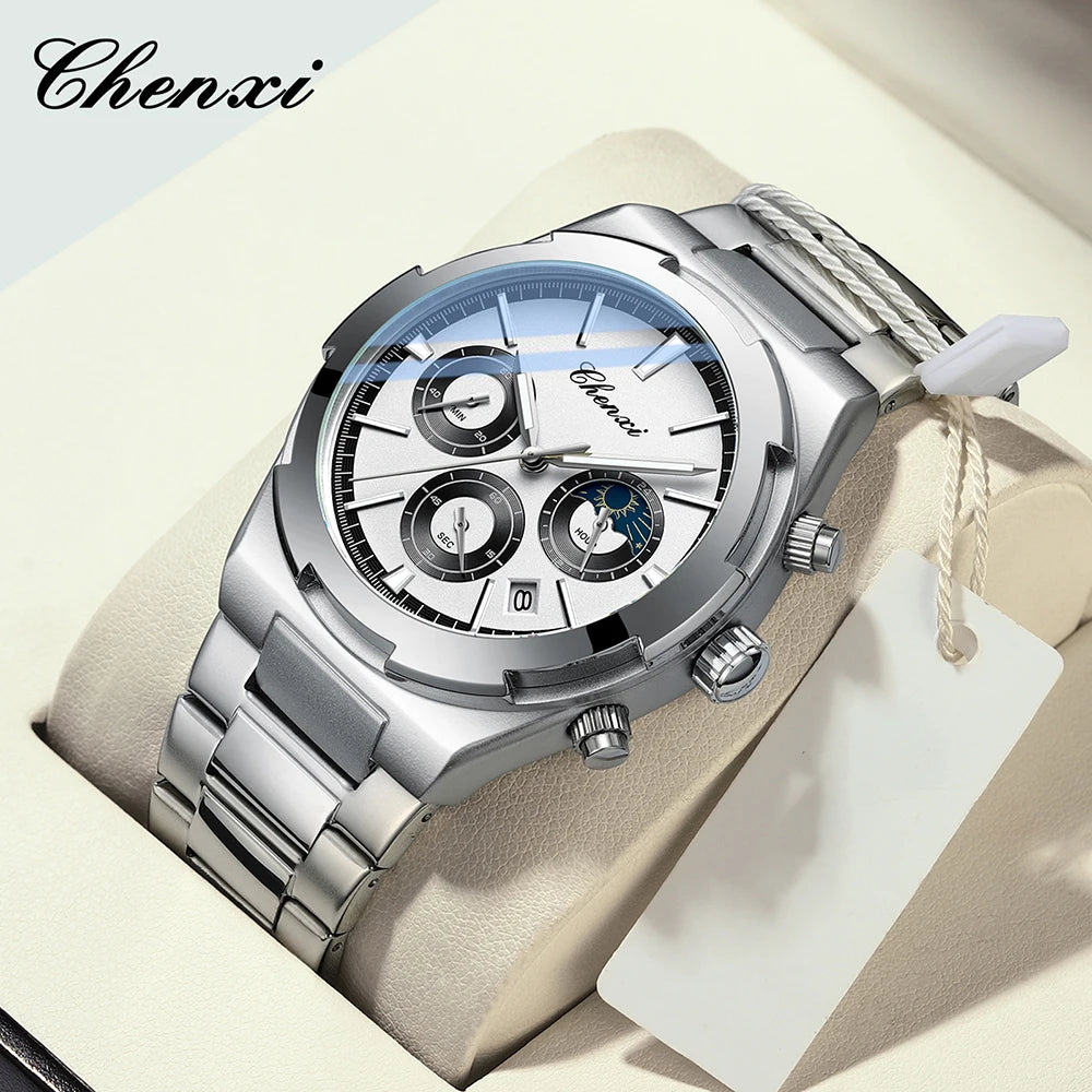 O relógio de pulso Selluve Relogio Masculino 2024 Novo, em prata com pulseira de aço inoxidável, é elegantemente apresentado em uma caixa. Ele apresenta um mostrador redondo com vários subdials, uma janela de data e inclui uma etiqueta branca na pulseira.